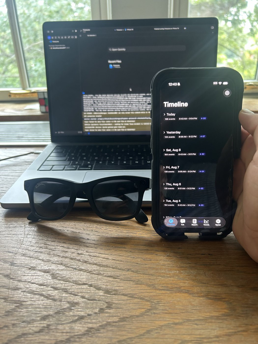 Meta Ray-Ban glasses next to an iPhone running TimeLens
